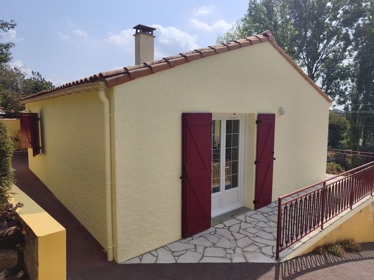 Maison aux murs jaunes et volets rouges repeinte par PRSV